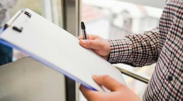 Person Holding Clipboard