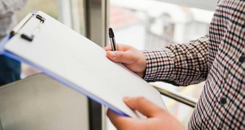 Person Holding Clipboard